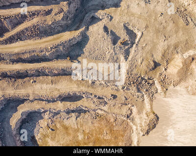 Granite quarry with two working excavators top aerial view Stock Photo