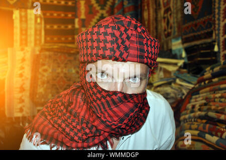 A young handsome man in a turban stares intently at you. Stock Photo
