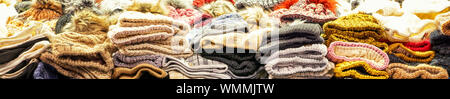 Colorful woolen hats as a panorama background. Stock Photo