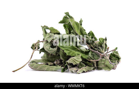 Dried mint leaves, isolated on white background. Dried peppermint pile. Medicinal herbs. Stock Photo
