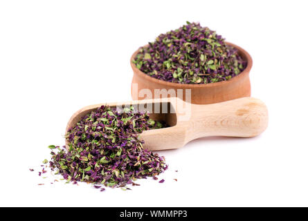 Dried thyme flowers in wooden bowl, isolated on white background. Natural herbs - thyme. Stock Photo