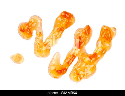 Orange thick jam drizzle, isolated on white background. Mandarin marmalade, sauce, topping drops. Top view.