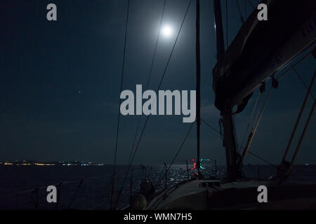 Sailing in the dark of the coast in Chalkidiki, Greece, with full moon Stock Photo