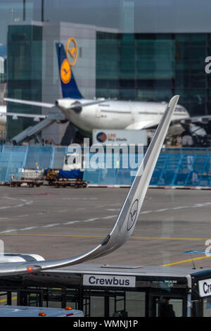 Close up portrait view of a Lufthansa Airbus aircraft winglet, with another in the background, at Frankfurt International Airport, Germany. Stock Photo