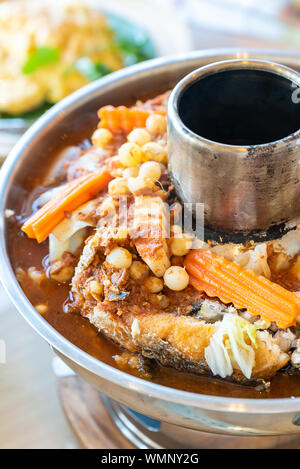 Sour curry soup with fried fish and seafood fish egg with mix vegatable, traditional thai food cuisine Stock Photo