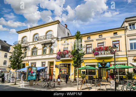 Tourists and locals enjoy a partly cloudy summer day in the coastal resort of Warnemunde, Germany, on the shores of the Baltic Sea. Stock Photo