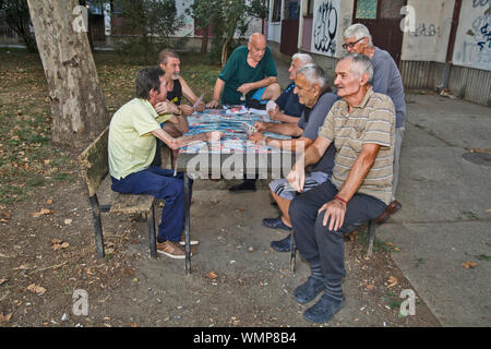 ZRENJANIN, SERBIA, SEPTEMBER 05,2019. A group of senior citizens mostly retirees having fun playing cards outdoors in the park. Stock Photo