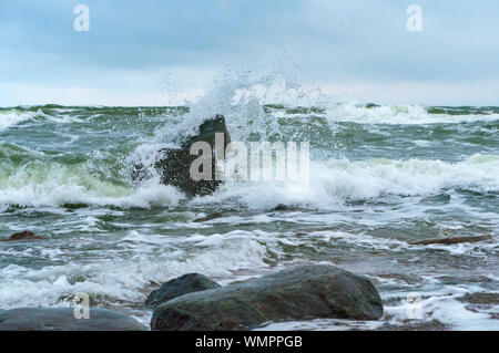 the waves beat against the rocks, the waves splash on the shore Stock Photo