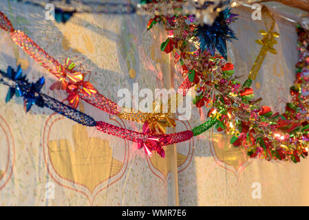 Colorful Sukkah decoration shiny garland at sunset light. Stock Photo