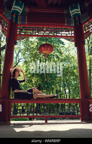 Young beautiful pregnant woman on a walk in the park of Warsaw, Poland. Lazienki Stock Photo