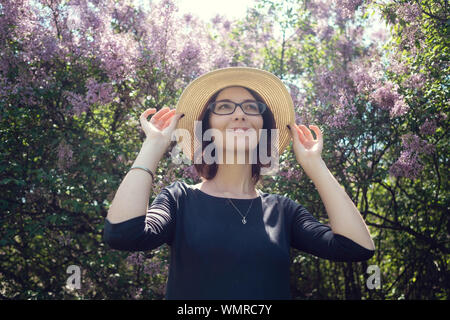 Young beautiful pregnant woman on a walk in the park of Warsaw, Poland. Lazienki Stock Photo