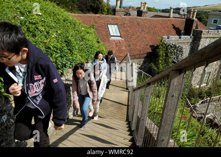Chinese family of tourists visiting Lewes Castle South Tower children climbing up steep stairs to view the town in East Sussex England UK KATHY DEWITT Stock Photo