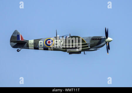 Supermarine Spitfire plane flying in the blue sky. Supermarine Spitfire XV TE184 Stock Photo