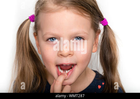 Child girl dropped the first milk tooth - preschooler girl with open mouth without milk tooth Stock Photo