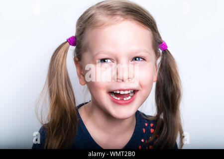 Child girl dropped the first milk tooth - preschooler girl with open mouth without milk tooth Stock Photo