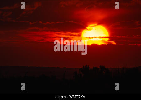 big red sun and clouds in the sunset Stock Photo