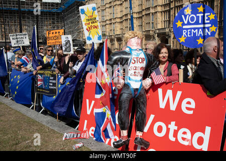 Brexit protester with an inflatable Boris Johnson and a message stop screwing our country in Westminster on the day after Parliament voted to take control of Parliamentary proceedings and prior to a vote on a bill to prevent the UK leaving the EU without a deal at the end of October, on 4th September 2019 in London, England, United Kingdom. Yesterday Prime Minister Boris Johnson faced a showdown after he threatened rebel Conservative MPs who vote against him with deselection, and vowed to aim for a snap general election if MPs succeed in a bid to take control of parliamentary proceedings to al Stock Photo