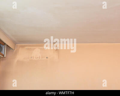 Part of a wall in an apartment with a dirty trace of a detached air condition appliance Stock Photo