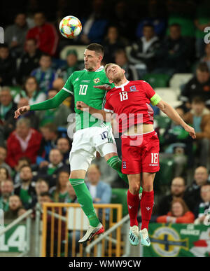 Northern Ireland's Kyle Lafferty (left) and Luxembourg's Laurent Jans battle for the ball during the International Friendly match at Windsor Park, Belfast. Stock Photo