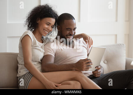 Smiling african american couple using tablet together. Stock Photo