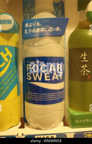 Three bottles of Japanese sports drinks in closeup in a vending machine with bottle of Pocari Sweat in the middle Stock Photo