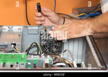 Technician repairing the computer. Concept of computer hardware, repairing, upgrade and technology . Stock Photo