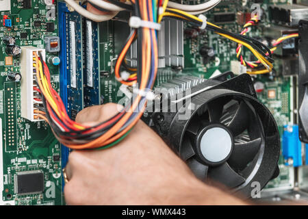 Technician repairing the computer, close up. Concept of computer hardware, repairing, upgrade and technology . Stock Photo