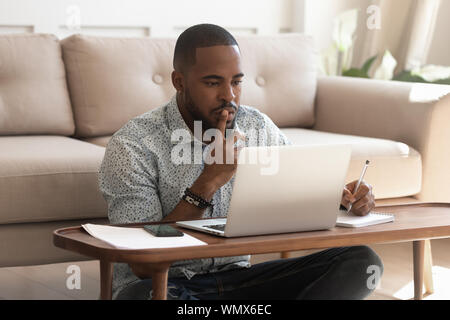 Young african american guy studying on online courses. Stock Photo