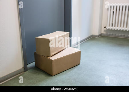 Close-up Of Cardboard Parcel Boxes Delivered Outside Front Door Stock Photo