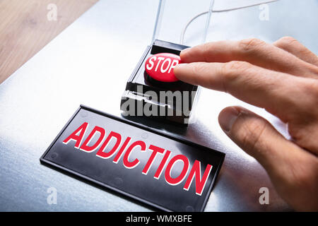 Man Pressing Stop Addiction Emergency Red Button Stock Photo