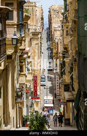 Malta, Valetta, Old Town, St. Ursula Street, narrow, steep street, with residential houses and the typical clad balconies, Stock Photo