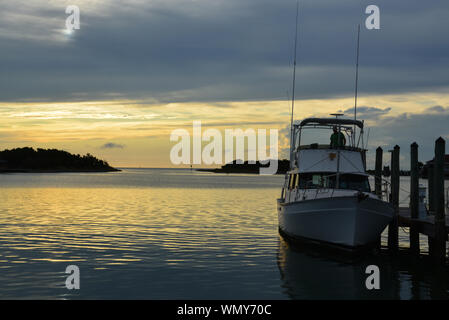 The sun sets over the harbor at Silver Lake on Ocracoke Island on the Outer Banks of North Carolina. Stock Photo