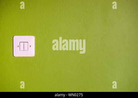 Vintage light switch on green wall Stock Photo
