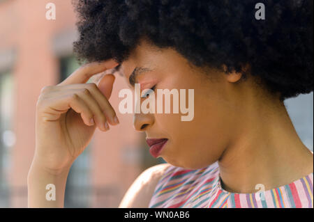 Young woman with headache Stock Photo