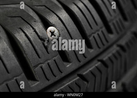 Screw damage in tire causes flat air pressure blowout spare wheel Stock Photo