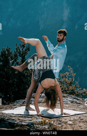 Two athletic young dancers making a performance at mountain peak Stock Photo