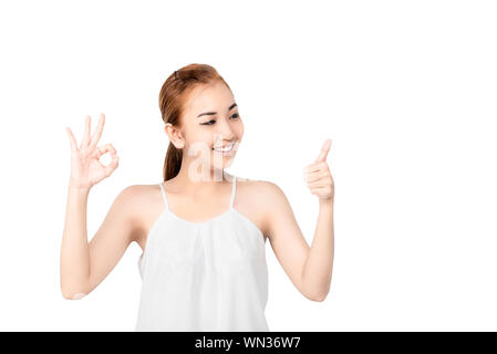 Closed up portrait of cheerful happy excited asian woman wearing a white casual and showing ok sign with beaming smile, clean skin and smooth straight Stock Photo