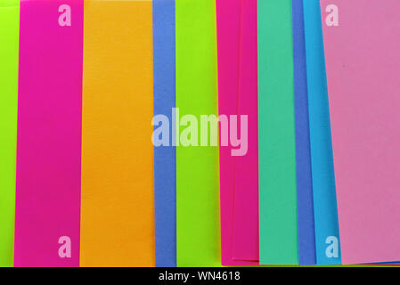 Blue,pink,yellow,purple,green,orange neon paper color for background. Striped geometric pattern of bright colors. Stock Photo