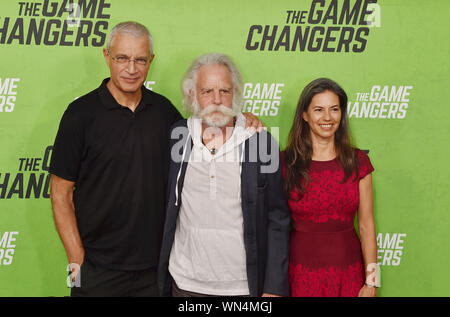 HOLLYWOOD, CA - SEPTEMBER 04: (L-R) Louie Psihoyos, Bob Weir and Natascha Muenter attend the LA Premiere Of 'The Game Changers' at ArcLight Hollywood on September 04, 2019 in Hollywood, California. Stock Photo