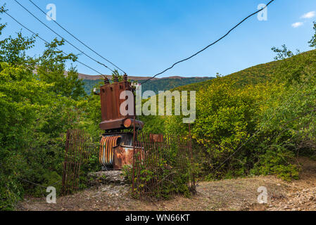 Old abandoned rusty electric transformer Stock Photo