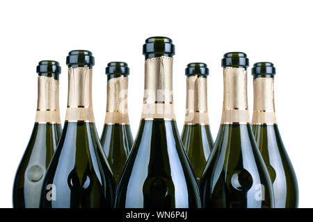 Top of open champagne bottles or sparkling wine botlles neck with golden label in several rows on a white background isolated close up Stock Photo