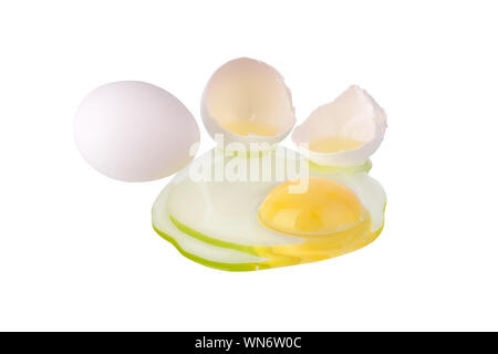 Broken white egg and one whole egg on white background isolated close up, cracked eggshell and liquid egg with yellow yolk, two halves of egg shell Stock Photo