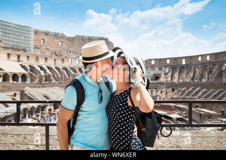 Young Tourist Couple Kissing In Inside Of Colosseum In Rome, Italy Stock Photo