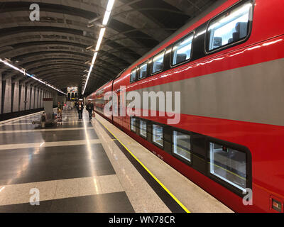 Vnukovo airport, Moscow, Russia - July 2019. Two-storey Aeroexpress train on the platform of railway terminal Stock Photo