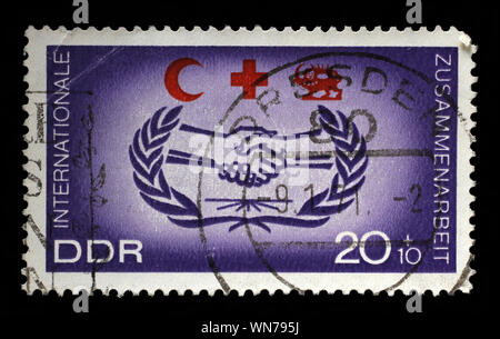 Stamp issued in Germany - Democratic Republic (DDR) shows International Cooperation, Red Cross series, circa 1966. Stock Photo
