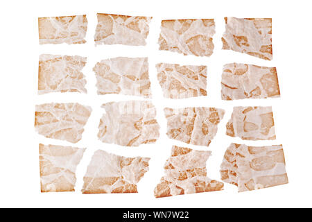 Torn sheets of brown aged paper on white background isolated close up, ragged shreds of old paper design ancient wrinkled damaged pattern page texture Stock Photo