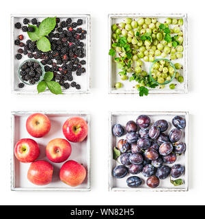 Apples, plums, gooseberries and blackberries on wooden tray collection isolated on white background. Healthy eating concept with summer fruits and ber Stock Photo