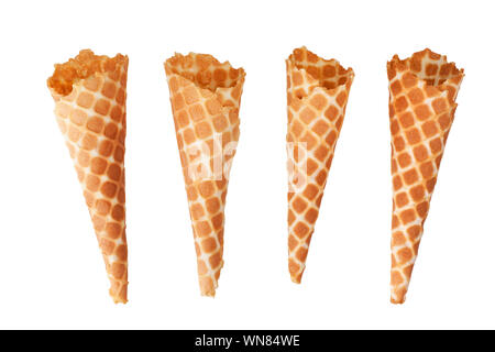 Four golden crispy ice-cream waffle cones on white background isolated close up Stock Photo