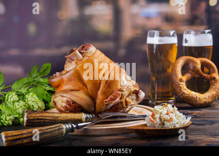 Pork knuckle, beer and pretzels Stock Photo