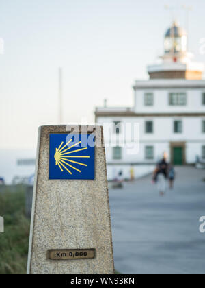 Marker of 0 km in Santiago way in cape of Finisterre with Finisterre ligthouse in Spain Stock Photo